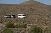 Photo: Our Expedition, F-350, and Econoline van parked in the desert
