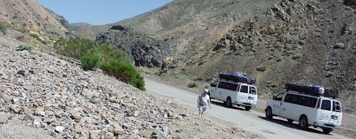 Decorative image showing college vans in desert