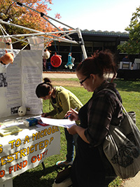 Students beside ASM display table on the Rocklin campus.